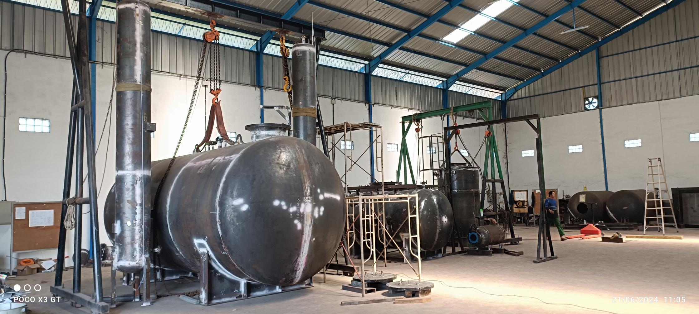 A photo inside Maxxtec's manufacturing facility of steel tanks of different sizes ready for painting.